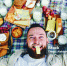 Goofy Male Lying on Picnic Blanket Tasting Yellow Cheese and Smiling - Газета Балтийский луч